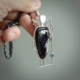 This is a very cool and creative fisherman hand made from Australian Black Jade and Sterling Silver. A fisherman who had caught a fish pendant hand crafted from sterling silver with Black Jade torso. A spectacular piece of art to wear.