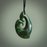 A hand carved large sized contemporary kour pendant. This is a piece of genuine jade jewellery, hand carved by Ric Moor. He has used New Zealand jade and has utilised his experience and carving skill to highlight the natural beauty of the stone. Delivered worldwide, postage is included in the price.