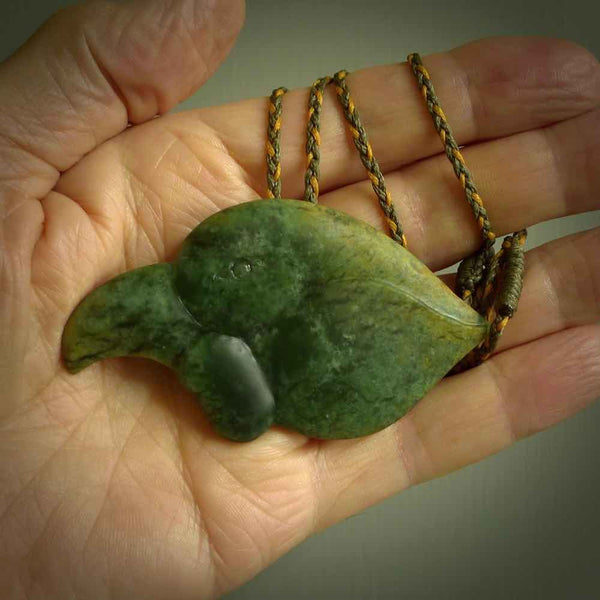 This picture shows a flower jade birds head. The bird is an extinct kokako - a saddleback that used to line in New Zealand's South Island. The cord is plaited and length adjustable. It is in two colours - khaki and burnt gold. We ship this worldwide.