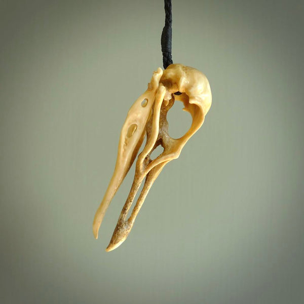 This is a hand carved deer antler huia bird skull pendant. It is made from deer antler, bone. This is a large sized necklace and is a very unique, one only, pendant that is a collectors piece. Hand carved deer antler huia skull necklace for men and women.