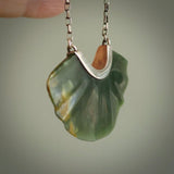 This is a very dark green fan design pendant that we has been carved here in New Zealand by Josey Coyle. It is carved from a piece of New Zealand Marsden flower Jade pounamu with Sterling Silver fittings and a sterling silver chain. A contemporary fan shaped pendant made to wear.