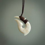 Hand carved cow bone hook pendant. Maori matau carving, hand carved jewellery for sale online.