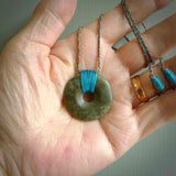 These are medium sized pendants - very finely carved. They are New Zealand Jade discs with a centre hole. It is suspended from a cord which is adjustable. These are beautiful pieces of expressive jade jewellery. Unique New Zealand made pendants for men and women. Perfect gifts for all.