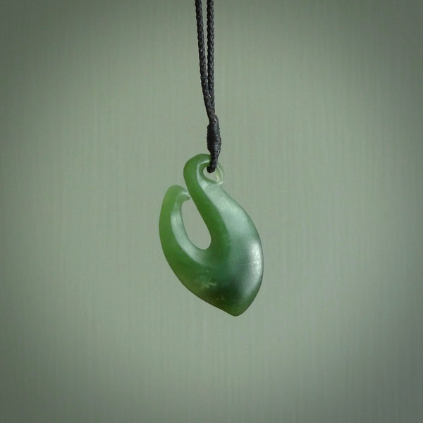 New Zealand jade hei-mate pendant. Hand carved in bright green jade by Ric Moor. The pendant is suspended from  black plaited cord and is finished in a satin matte polish.