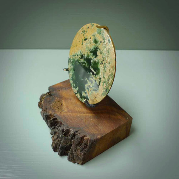 Hand carved New Zealand Flower Jade Disc with wooden stand sculpture. Hand carved here in New Zealand by Alex Sands Studio. This is a 'one only' sculpture, a beautiful display piece.
