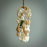 Hand carved bone manaia pendant. This is a complex carving by New Zealand carver and artist, Andrew Doughty. It is an intricate representation of a manaia carved to represent protection. It can be worn but is also a quality that warrants display.