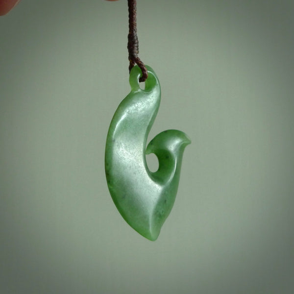This matau is carved from a very striking New Zealand  jade. It is both intricate and simple in design - it has hidden folds and smooth curves. A piece to be worn or displayed - the carving and the jade are both magnificent. One only jade hook necklace hand made by Ric Moor.