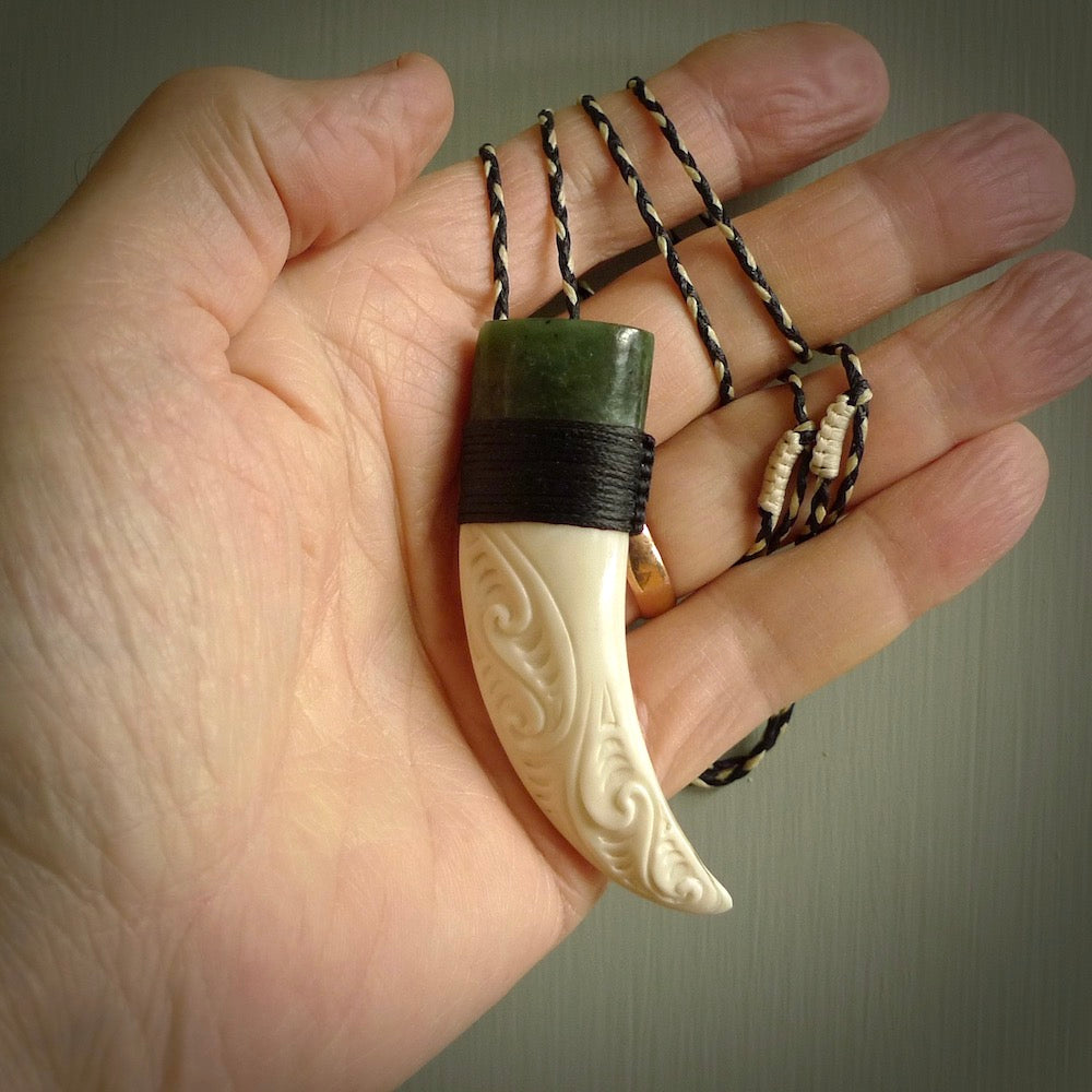 Boars Tusk Pendant with a jade cap. Hand made pendant carved from a boars tusk. Hand made ethnic or maori jewellery for sale by NZ Pacific online.