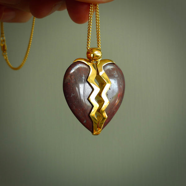 This is a handcarved love heart pendant made from a gorgeous and striking piece of red jasper stone with gold plated silver. This is a superbly carved and very unique piece if custom jewellery. For sale online from NZ Pacific.