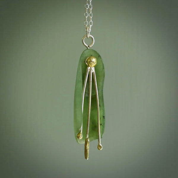 This kowhai flower drop pendant is beautifully hand made with gorgeous flair. It is fashionable and perfect for a women with style. Hand carved from a gorgeous piece of New Zealand jade with Gold leaf coating and sterling silver - this is an elegant and beautiful piece of art to wear.