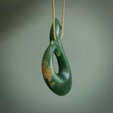 This matau is carved from a very striking New Zealand jade. It is both intricate and simple in design - it has hidden folds and smooth curves. A piece to be worn or displayed - the carving and the jade are both magnificent. One only jade hook necklace hand made by Ric Moor.