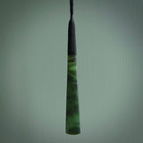 This photo shows a large jade drop shaped pendant. It a a lovely two-one green jade. Majority of this piece is a dark green colour with a semi-translucent top of the drop. The cord is black and is adjustable in length. Hand carved by Darren Hill.