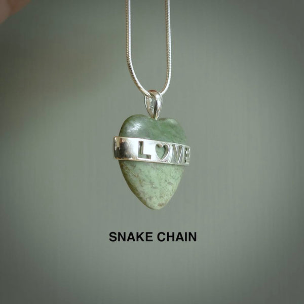 Hand crafted New Zealand jade love heart necklace. This piece has  a sterling silver love written across its' body. This necklace is provided with a sterling silver chain.