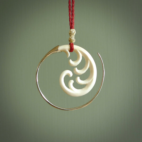 Hand carved pendants made from bone with sterling silver. NZ Pacific contemporary Koru pendants for sale online.