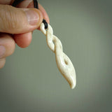 A hand carved twist design pendant from Whale Bone. The cord is black and adjustable in length. Large hand made twist necklace by New Zealand artist Kerry Thompson.