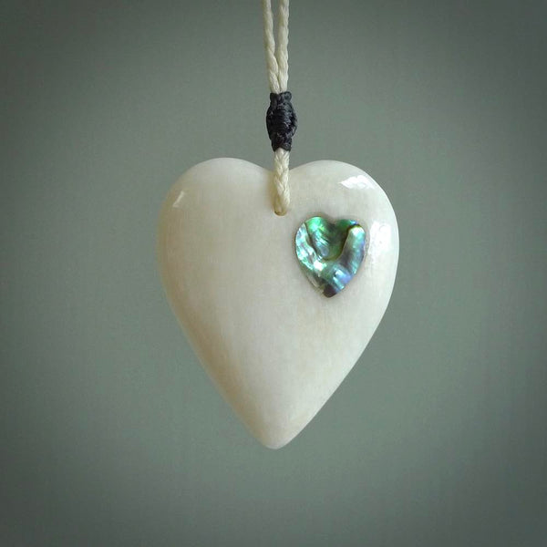 HAND CARVED HEART PENDANT. CARVED FROM BONE. PAUA HEART INSERT. HAND MADE BY NZ PACIFIC. HANDMADE JEWELLERY FOR SALE ONLINE.