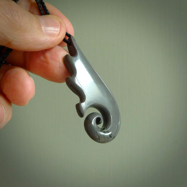 Hand made large New Zealand Argillite Koru pendant. Hand carved in New Zealand by Kerry Thompson. Hand made jewellery. Unique large Argillite Stone Koru with adjustable cord. Free shipping worldwide.