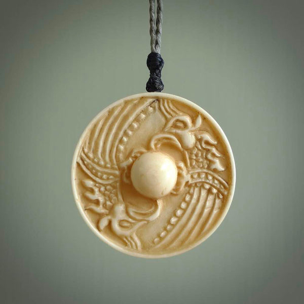 This piece is a hand carved contemporary bone shield pendant. Yuri Terenyi has carved this from Bone. It is a delightful, artistic piece of jewellery. One only necklace.