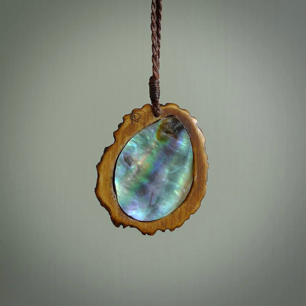 Hand carved deer antler Paua Shell Pendant. Made from Red Deer antler in New Zealand. Unique Pāua Shell necklace hand made from deer antler by master bone carver Fumio Noguchi. Spectacular collectable work of art, made to wear. One only pendant, delivered to you at no extra cost with express courier.