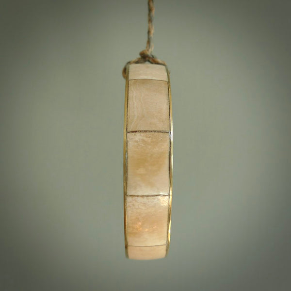 This piece is a hand made bracelet. It is made from selected pieces of woolly mammoth tusk which we have cut and polished and then inset into a brass bracelet. It is a very striking piece one of a kind and truly beautiful.