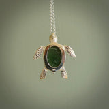 New Zealand Jade stone turtle in Sterling silver engraved casing. Hand carved jewellery made by NZ Pacific and for sale online. Moana, Ocean, jewellery hand carved in fire agate and Sterling Silver turtle necklace.