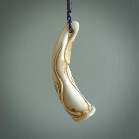 Hand carved incredible Boars Tusk Japanese catfish carving. A stunning work of art. This pendant was hand carved in boars tusk with Goat Horn inlay for the eyes by Fumio Noguchi. A one off collectors item that has been hand crafted to be worn or displayed. Hand made boars tusk Namazu earthquake fish necklace.