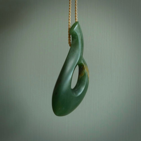 This matau is carved from a very striking New Zealand jade. It is both intricate and simple in design - it has hidden folds and smooth curves. A piece to be worn or displayed - the carving and the jade are both magnificent. One only jade hook necklace hand made by Ric Moor.