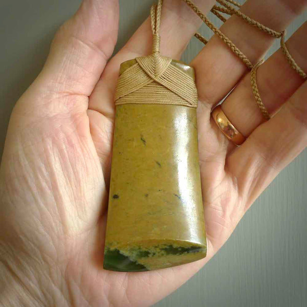 This is a lovely large toki pendant we've made from a gorgeous New Zealand Flower Jade. It is finished in a soft polish and is bound with our hand plaited, adjustable cord. These are wonderful pieces that are very attractive and will last a lifetime.