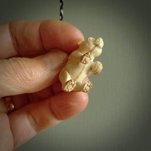 This picture shows a pendant that we designed in Woolly Mammoth Tusk. It is a little Panda bear that has a walking stance and is carved in detail. A really attractive and eye-catching piece of handmade jewellery. The cord is hand plaited braid in black and pale honey and the length can be adjusted.