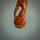 Hand carved stained bone female pendant in a repose shape with her cat. Made from natural bone. Bone jewellery from the Pacific for sale online. Female pendant for men and women.