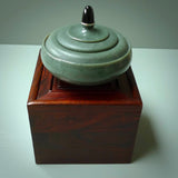 This shows the jade bowl sitting on top of the Rosewood box that it will be delivered with.