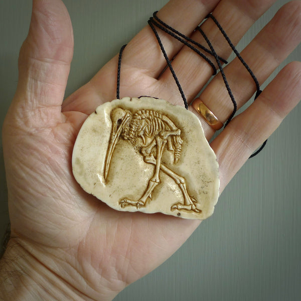 A hand carved kiwi skeleton pendant carved from a piece of deer antler crown. This is a work of art carved by Fumio Noguchi who is renowned for his skill in bone carving. The kiwi is a native bird to New Zealand. This is a great piece representing this very cool bird.