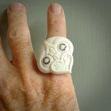 Hand carved natural bone tiki face ring. Natural bone ring with tiki face design. Hand made ring, delivered with international airmail. Postage is included. One only bone ring with paua shell eyes.