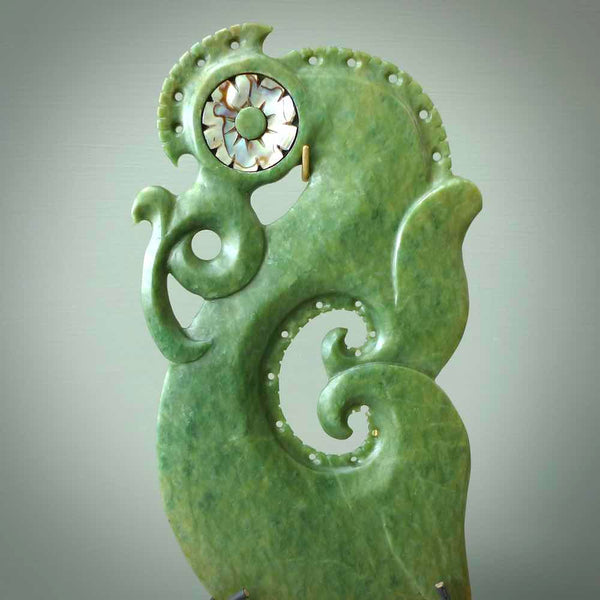 Hand carved New Zealand Jade Manaia sculpture with wooden stand. This is a large New Zealand Flower Jade Manaia sculpture hand carved here in New Zealand. This is a one only work of art and will be shipped to you with express courier.