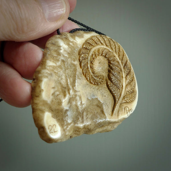 A hand carved kiwi skeleton pendant carved from a piece of deer antler crown. This is a work of art carved by Fumio Noguchi who is renowned for his skill in bone carving. The kiwi is a native bird to New Zealand. This is a great piece representing this very cool bird.