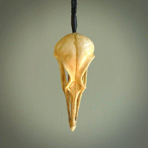 This is a hand carved deer antler huia bird skull pendant. It is made from deer antler, bone. This is a large sized necklace and is a very unique, one only, pendant that is a collectors piece. Hand carved deer antler huia skull necklace for men and women.