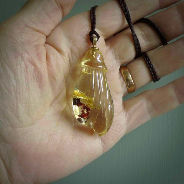 This pendant is handcrafted from rare Kauri Gum Amber. We supply this with a sterling silver chain or an adjustable cord. It is a graceful and very interesting piece that will attract admiration and comment. Hand carved here in New Zealand. Kauri Gum kowhai flower necklace.