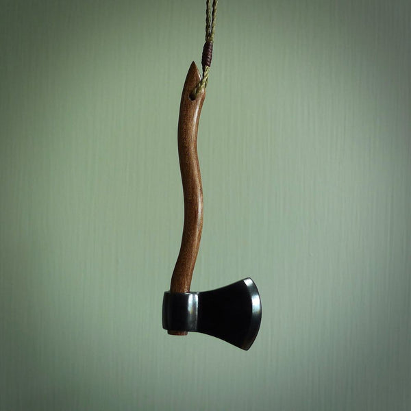 A striking hand carved axe pendant that we've called the Lumberjill. These are carved with a jade head and a hardwood handle. The cords are hand plaited in our waxed polyester which is robust, strong and durable. We ship these worldwide with DHL express courier.