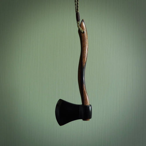 A striking hand carved axe pendant that we've called the Lumberjill. These are carved with a jade head and a hardwood handle. The cords are hand plaited in our waxed polyester which is robust, strong and durable. We ship these worldwide with DHL express courier.