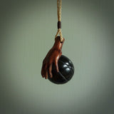 This is a very cool pendant that we've had carved for all you Basketball fans. The DUNK is a pendant with a woolly mammoth tusk hand holding a black jade basketball. We provide this on an adjustable black cord, and we ship worldwide. A very cool pendant, different, edgy and very wearable.