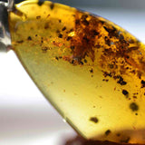 This pendant is handcrafted from rare Burmese amber. We supply these with a sterling silver chain. It is a graceful and very interesting piece that will attract admiration and comment.