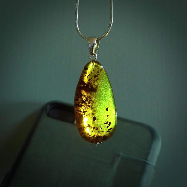 This pendant is handcrafted from rare Burmese amber. We supply these with a sterling silver chain. It is a graceful and very interesting piece that will attract admiration and comment.