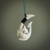 Hand carved bone hook with dolphin. This is a marine-themed pendant which we have made for dolphin lovers and for those of us that love the sea. This piece is handcarved from natural bone  and is shipped worldwide free.