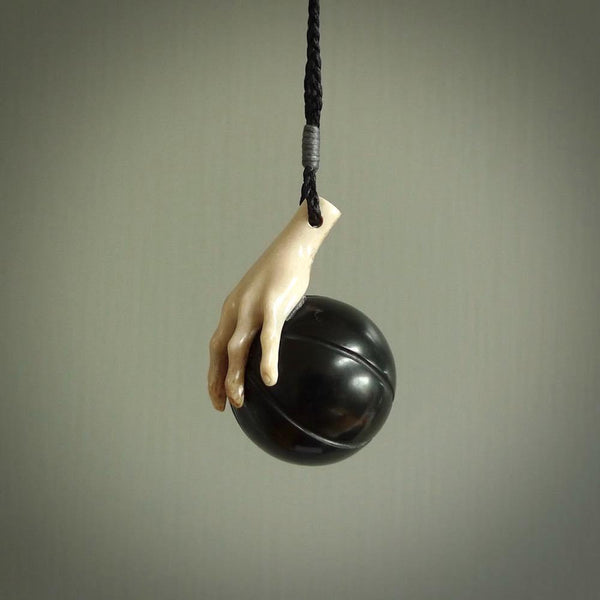 This is a very cool pendant that we've had carved for all you Basketball fans. The DUNK is a pendant with a woolly mammoth tusk hand holding a black jade basketball. We provide this on an adjustable black cord, and we ship worldwide. A very cool pendant, different, edgy and very wearable.