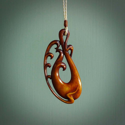 Bone Koru carving. Handmade in New Zealand by Yuri Terenyi for NZ Pacific. Exotic handcarved jewellery for sale online. Ethnic art from the South Pacific.