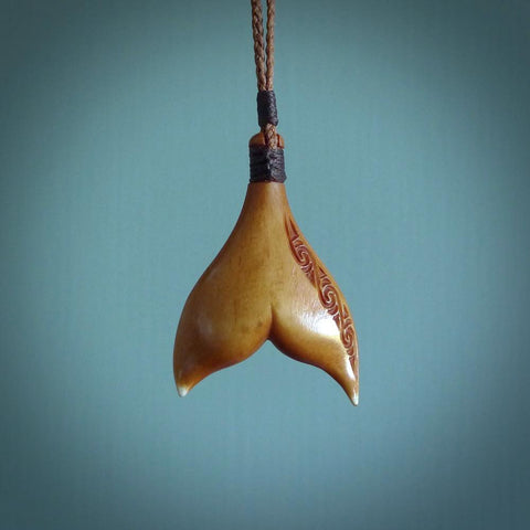 Hand carved bone whaletail pendant. Made by Yuri Terenyi for NZ Pacific. Hand crafted jewellery. Art to wear and for sale online.