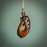 Bone Koru carving. Handmade in New Zealand by Yuri Terenyi for NZ Pacific. Exotic handcarved jewellery for sale online. Ethnic art from the South Pacific.