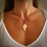 Hand carved woolly mammoth tusk fern pendant. Made in New Zealand. Unique hand made gifts from NZ Pacific. Hand carved fern necklace from ancient woolly mammoth tusk.