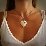 HAND CARVED HEART PENDANT. CARVED FROM BONE. PAUA HEART INSERT. HAND MADE BY NZ PACIFIC. HANDMADE JEWELLERY FOR SALE ONLINE.
