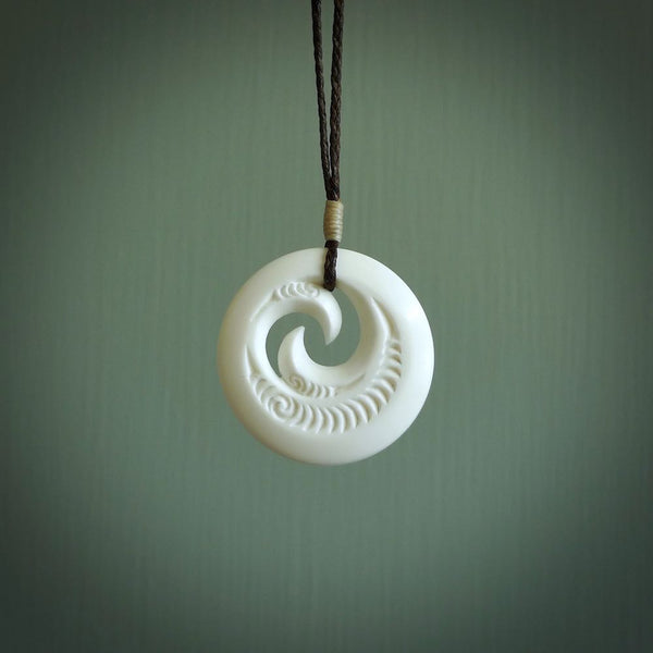 A hand carved and engraved koru pendant carved for us by Yuri Terenyi. These are beautiful little pieces are emblematic of the well known and loved Koru design.